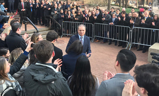 Supporters applaud Preet Bharara as he exits the Southern District U.S. Attorney's Office yesterday.